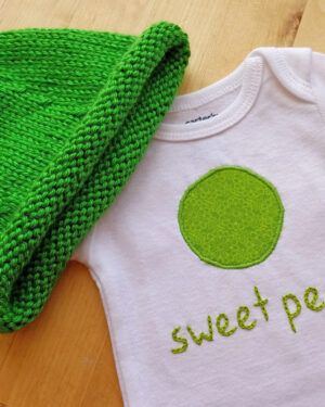 sweet pea bodysuit and hat gift set on table