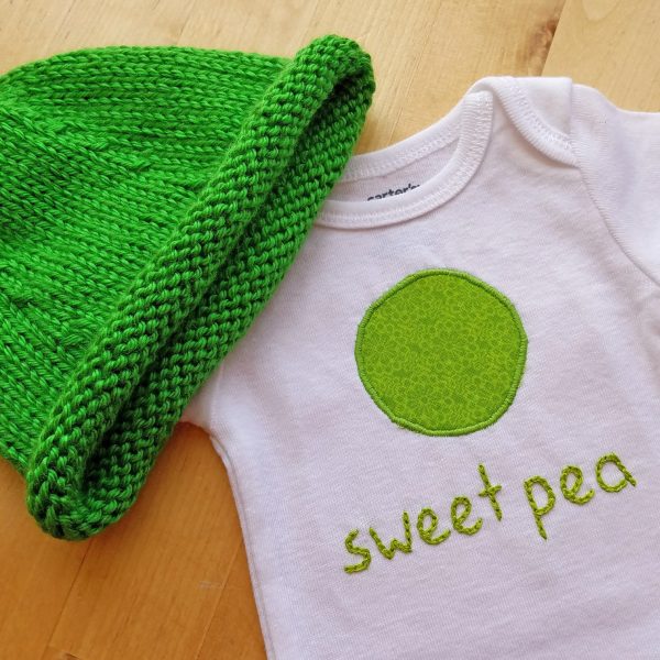 sweet pea bodysuit and hat gift set on table