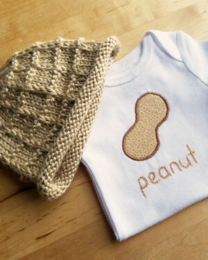 peanut onesie and hat on table