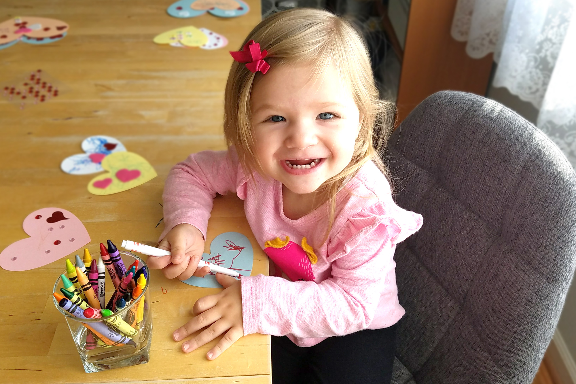 Little girl making valentine's day cards