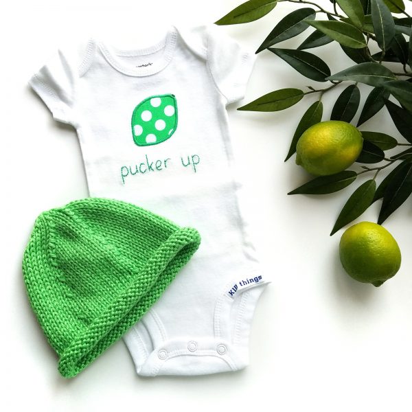 lime bodysuit and hat flatlay