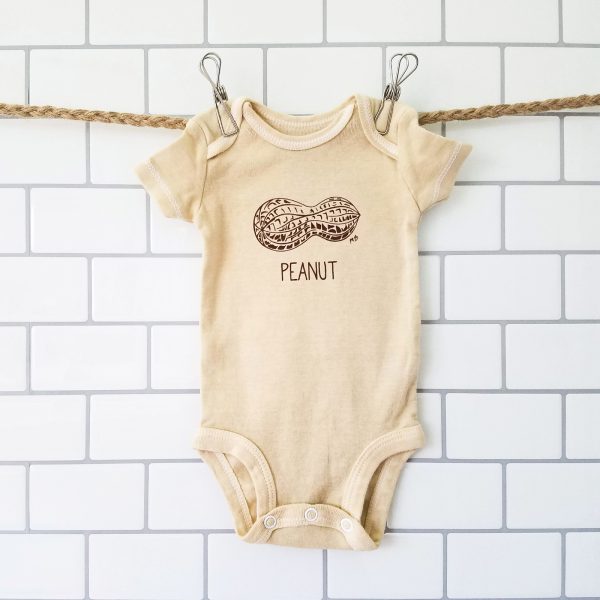 hand dyed, screen printed peanut bodysuit hanging up