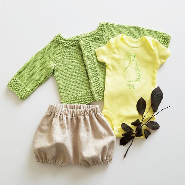 hand dyed, screen printed pear bodysuit flatlay with linen bloomers and green apple sweater