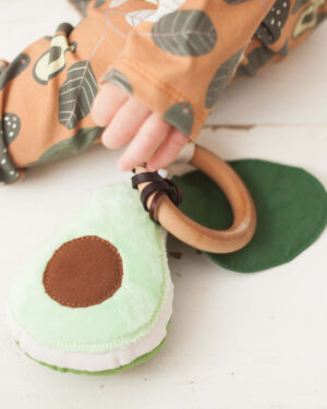 avocado teether detail with baby's hand