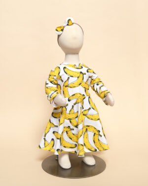 long sleeve luna dress in banana print on mannequin with zoe headband
