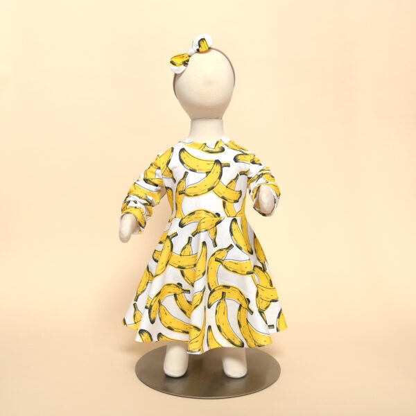 long sleeve luna dress in banana print on mannequin with zoe headband
