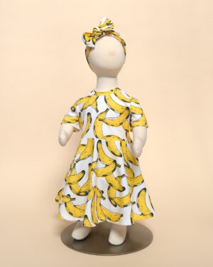 short sleeve luna dress in banana print on mannequin with eva headband