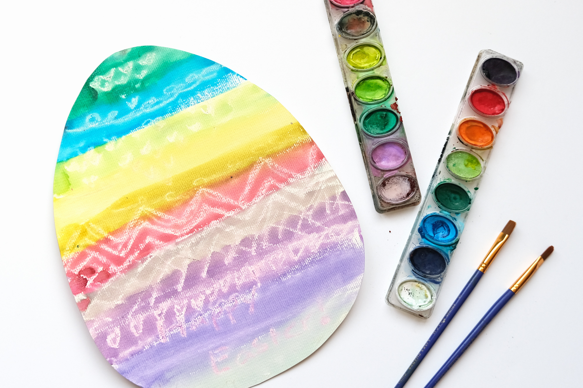 watercolor easter egg craft - finished eggs with brushes and paint